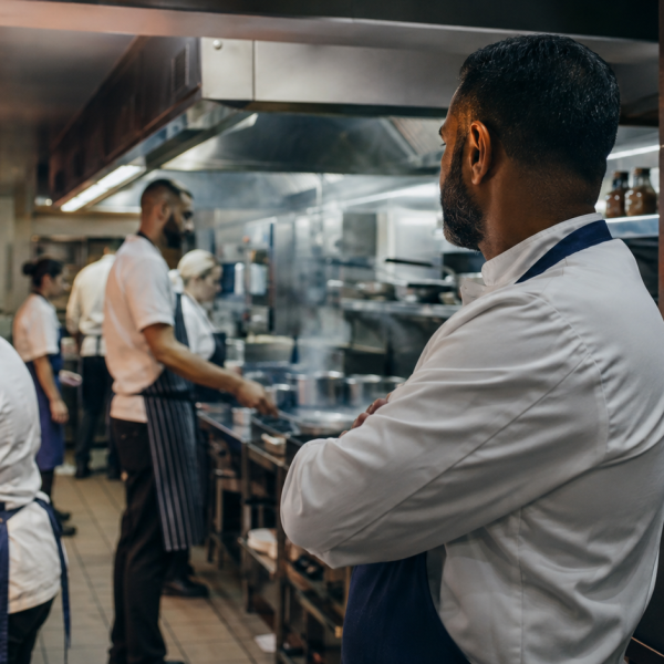 A busy British restaurant kitchen with rota and secure staff files.